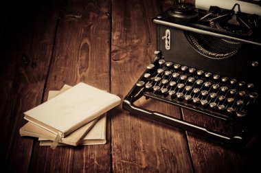 Vintage typewriter and old books, touch-up in retro style clipart