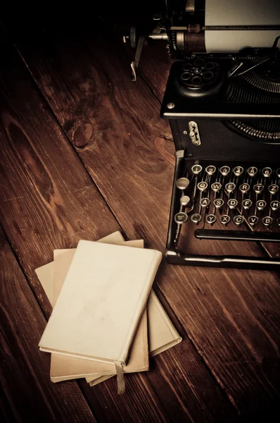 Vintage typewriter and old books, touch-up in retro style — Stock Photo, Image