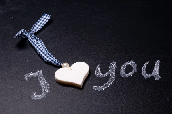 The heart lying on the blackboard, the concept of Valentine's Da — Stock Photo, Image