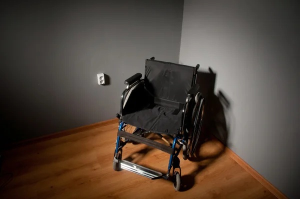 Koyu arka plan ve boş gölgesinde closeup boş tekerlekli sandalye — Stok fotoğraf