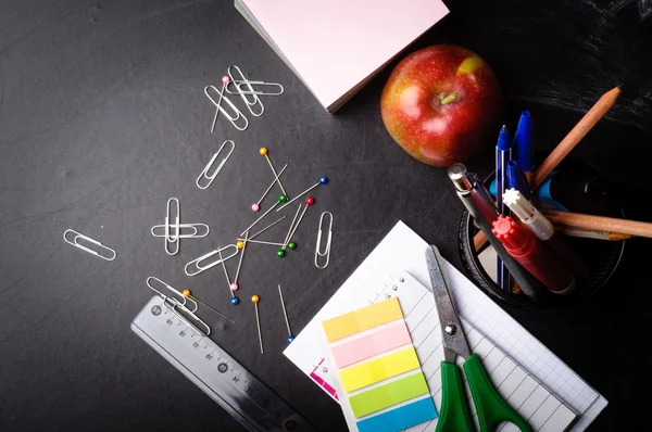 School supplies on the background of blackboard — Stock Photo, Image