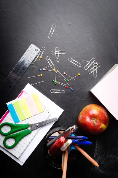 School supplies on the background of blackboard — Stock Photo, Image