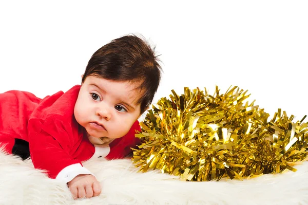 Sweet baby dress as santa looking away with golden tinsel — Stock Photo, Image