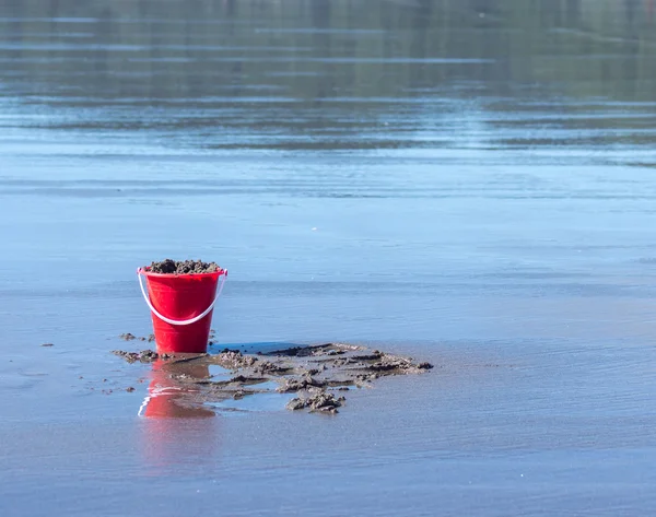 Bucket of sand on beach — Stock Photo, Image