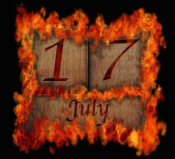 Burning wooden calendar July 17. — Stock Photo, Image