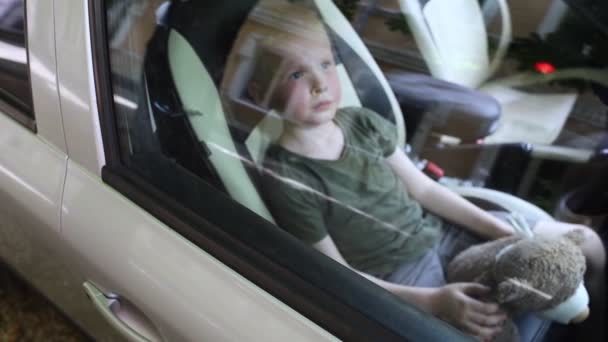 子供は車に閉じ込められている 金髪の少年は水なしで自動車で閉じられます 彼は熱く 顔は赤くなっている 無責任な両親は子供を熱い車の中に置き去りにした 子供のための貧しいケアの概念 — ストック動画
