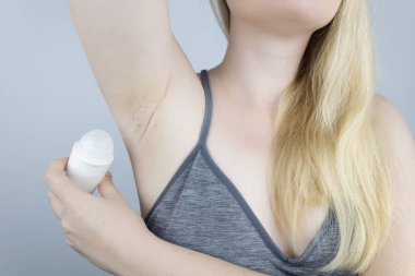 Armpit rash. Underarm skin irritation. Blonde girl shows irritation on the skin after using a razor, trimmer, deodorant or antiperspirant. Allergy or irritation. Acne or red spots