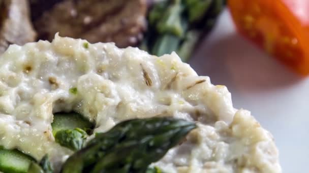 Medallions of pork tenderloin with asparagus risotto — Stock Video
