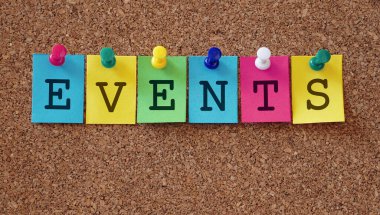 Upcoming event concept with events word and sign on colorful paper notes pinned with multicolored push pins on a cork message notice board lettering concept with copy space. 