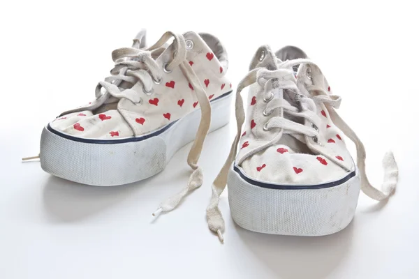 Red hearts on white sneakers — Stock Photo, Image