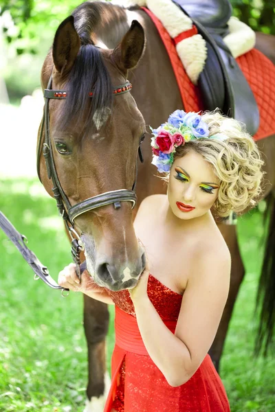 Woman with bright makeup on the horse outdoors — Stock Photo, Image