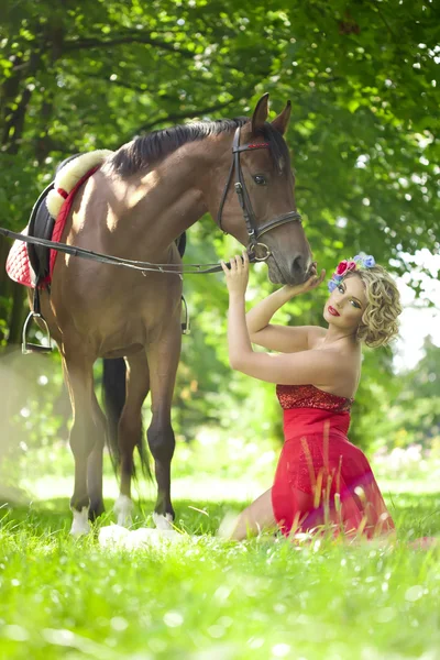 Donna con trucco luminoso sul cavallo all'aperto Foto Stock Royalty Free