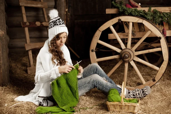 Woman in the village barn with knitting in hand — Stock Photo, Image