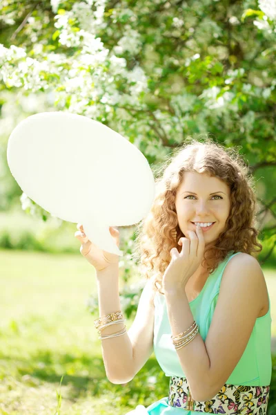Woman holding white bubble talk in summer park — Stock Photo, Image
