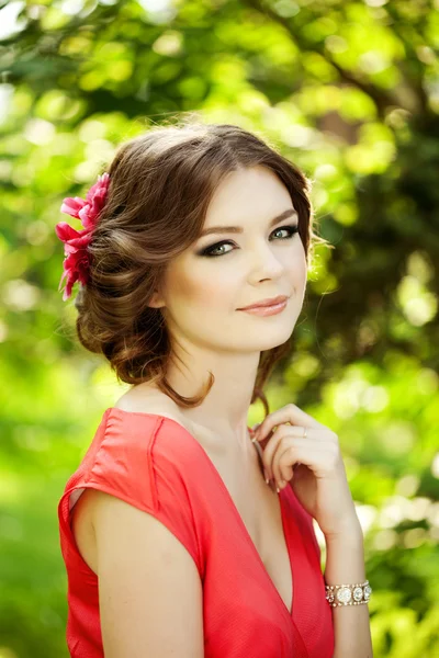Beautiful woman with a flower in the hairstyle Royalty Free Stock Photos