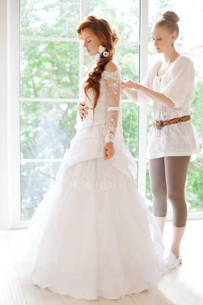 Beautiful bride wears dress by stylist — Stock Photo, Image