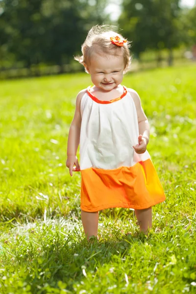 Cute little baby girl on grass in nature — Stock Photo, Image