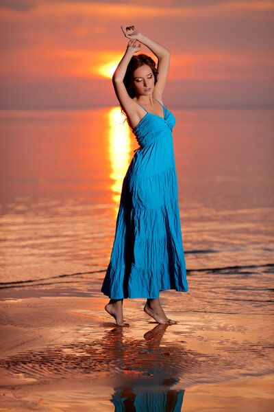 Happy Woman enjoying in Sea Sunset.