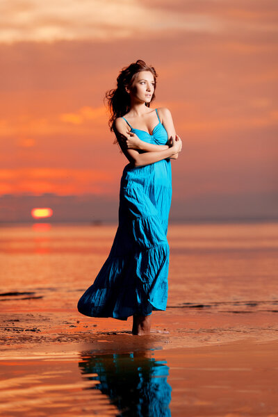 Happy Woman enjoying in Sea Sunset