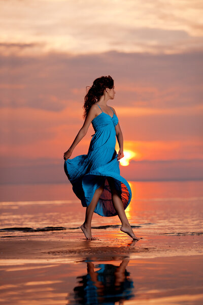Happy Woman enjoying in Sea Sunset.