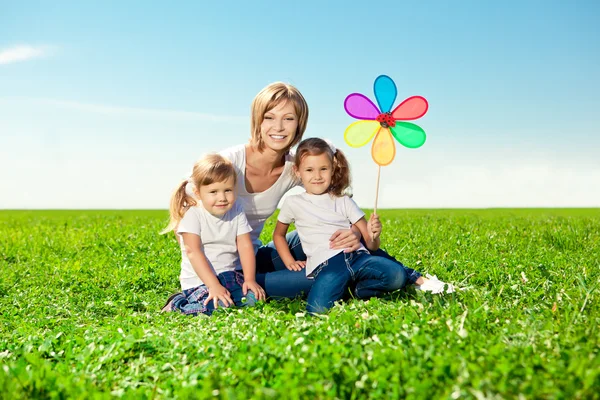 Happy family together in outdoor park at sunny day. Mom two dau — Stock Photo, Image