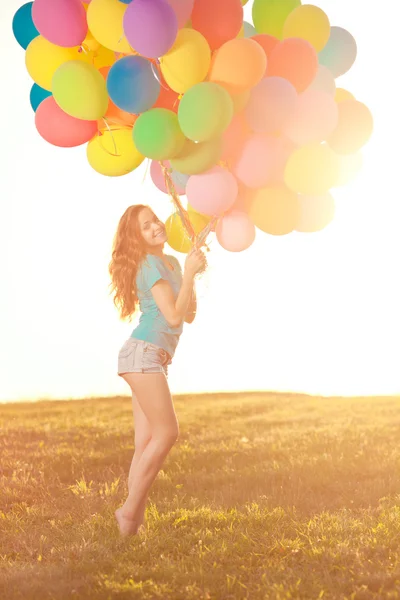 Happy birthday woman against the sky with rainbow-colored air ba — Stock Photo, Image