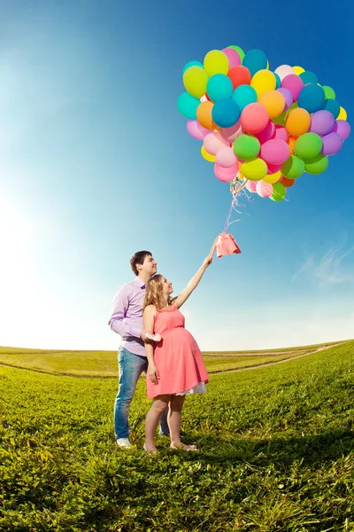 Jeune belle femme enceinte en bonne santé avec son mari et son ballon Images De Stock Libres De Droits