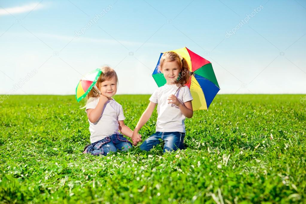 Two little girls in outdoor park at sunny day. Sisters in the