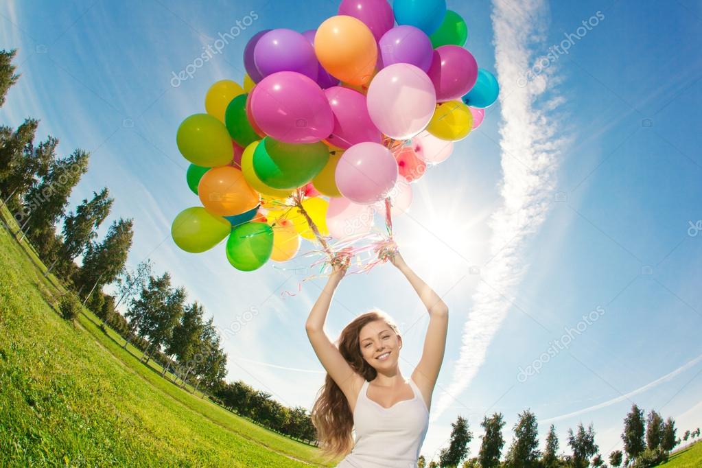 Happy birthday woman against the sky with rainbow-colored air ba