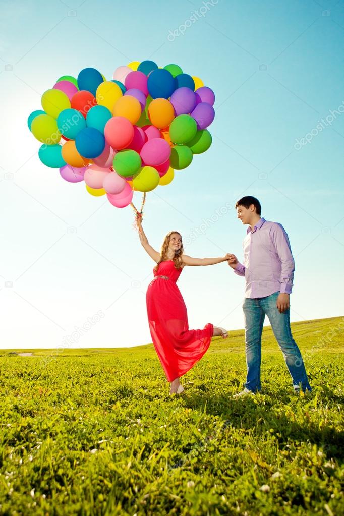 Young healthy beauty pregnant woman with her husband and balloon