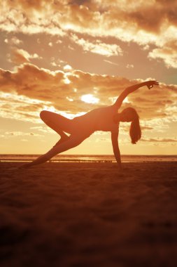 genç güzel ince kadın silueti beac yoga uygulamaları