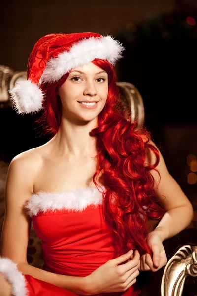 Young beautiful smiling santa woman near the Christmas tree. Gir — Stock Photo, Image