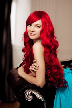 Young woman with luxurious long beautiful red hair in a blue fas clipart