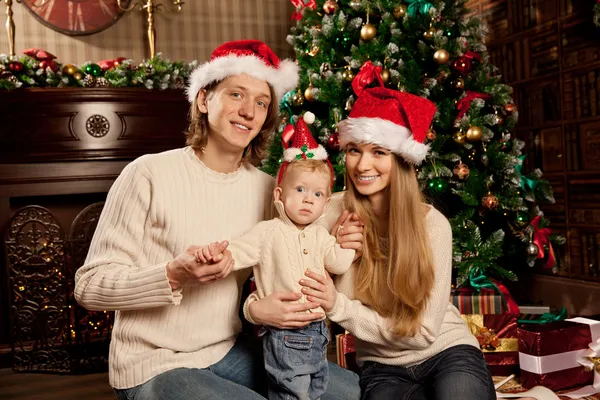 Happy smiling family near the Christmas tree celebrate New Year. — Stock Photo, Image