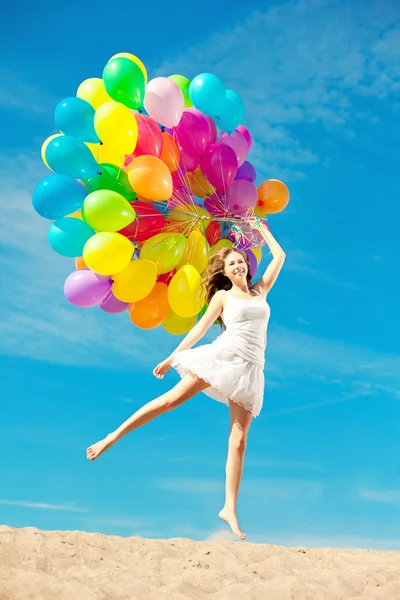 Beautiful young stylish woman with ainbow balloons in hands agai — ストック写真