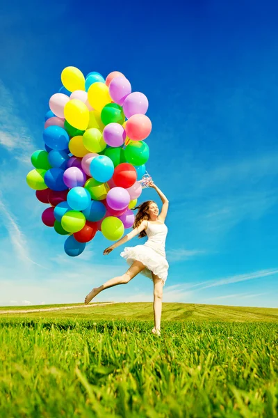 Happy birthday woman against the sky with rainbow-colored air ba Stock Image