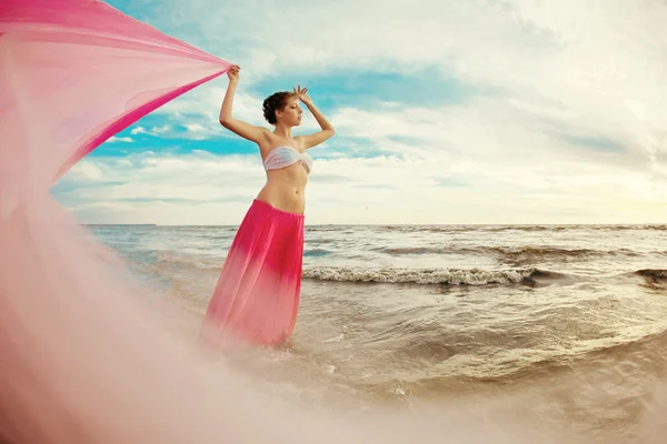 Woman with a tissue in his hands on the beach Stock Image