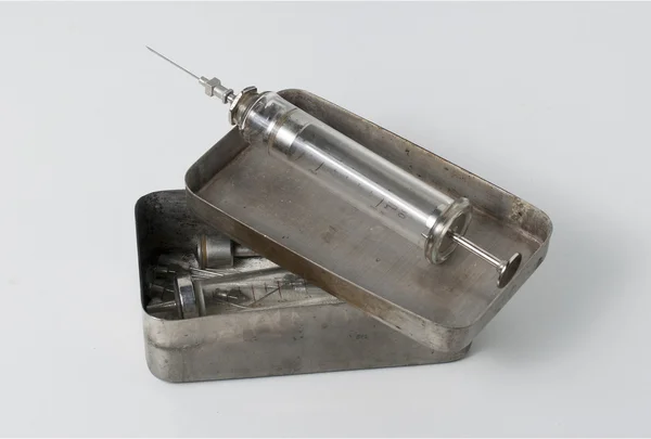 Old syringe with opened sterilizing box — Stock Photo, Image