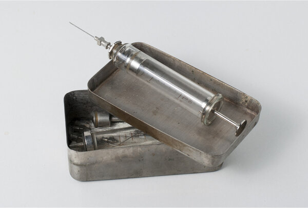 Old syringe with opened sterilizing box