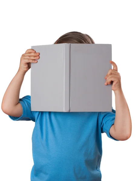 Little girl reading a book and hide her face. Isolated — Stock Photo, Image