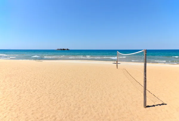 Beach Volleyball net on sandy beach with sea — Stock Photo, Image