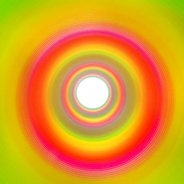 Rainbow tunnel made out of slinky leading to white background — Stock Photo, Image