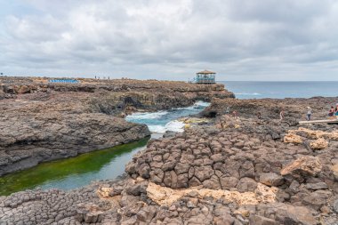 SAL ISLAND, CAPE VERDE - JUNE 22.2022: Buracona - The Blue Eye of Cabo Verde, people at the walking way