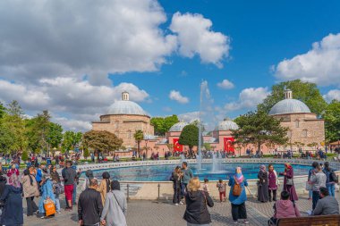 ISTANBUL, TURKEY - MAY 19.2022: People at the Sultan Ahmet park, in the background Haseki Huerrem Sultan historic building