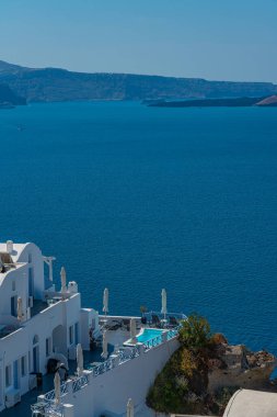 OIA, GREECE - MAY 22.2022: Building with a Pool in Oia with traditional white houses, Santorini island