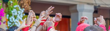 CAMBRILS, SPAIN - SEPTEMBER 04.2022: Hands at a Castells Performansı, Castell geleneksel olarak festival, panorama