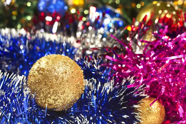 Golden Christmas ball and tinsel — Stock Photo, Image