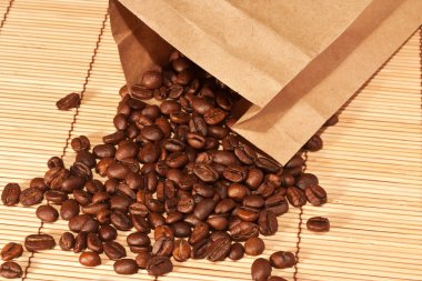 Coffee beans spilled out of the bag clipart