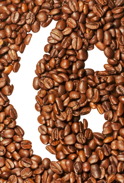 Улыбающееся лицо на фоне кофейных зерен — стоковое фото