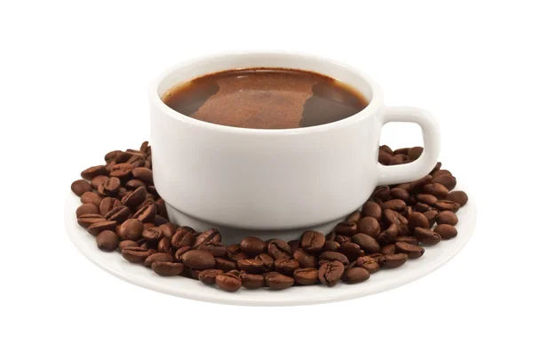 White cup of coffee with beans on a plate — Stock Photo, Image